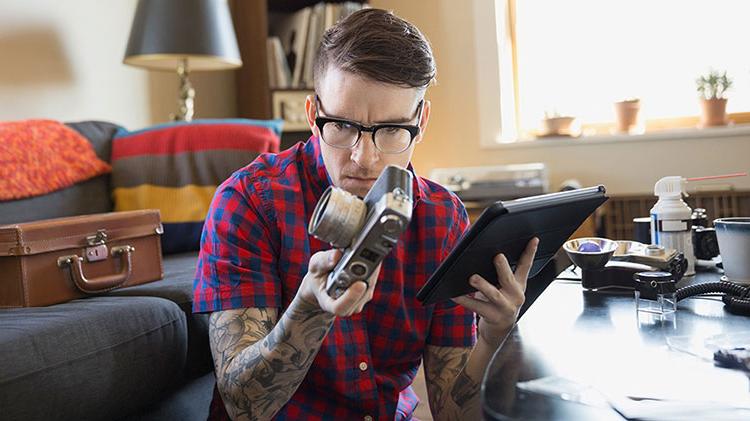 A man is reviewing the appraisal of an antique camera.